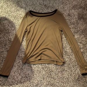 small, brown tee with a darker brown lining on the neck and the sleeves